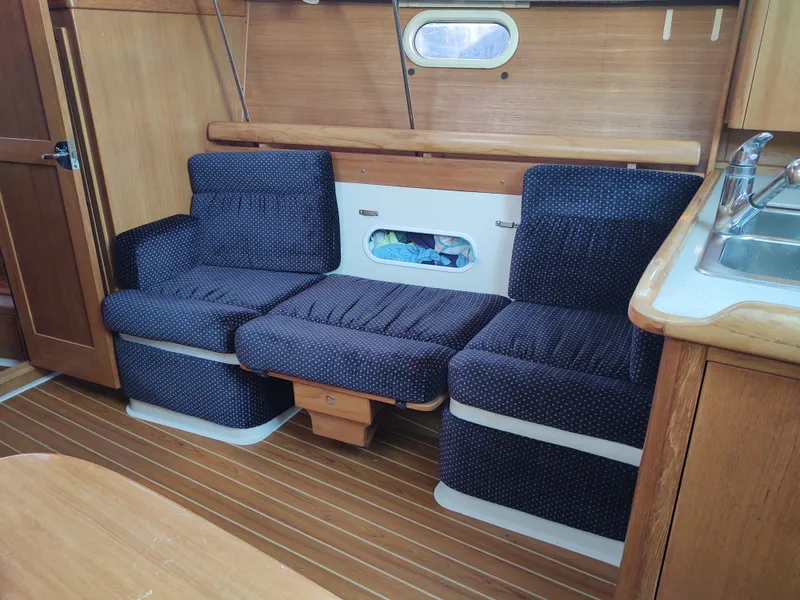 Slide: The Image of Interior of 2006 Catalina 350 MK II yacht with blue seating and wooden finishes. - 32