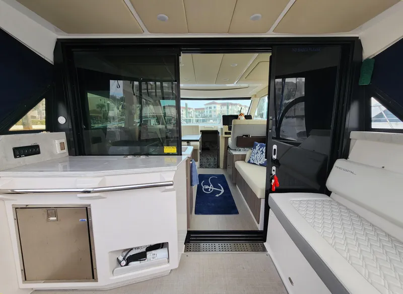 Slide: The Image of 2022 Regal 38 Grande Coupe interior with modern seating and kitchenette. - 12