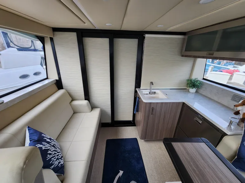 Slide: The Image of Interior of 2022 Regal 38 Grande Coupe yacht with modern seating and kitchenette. - 18