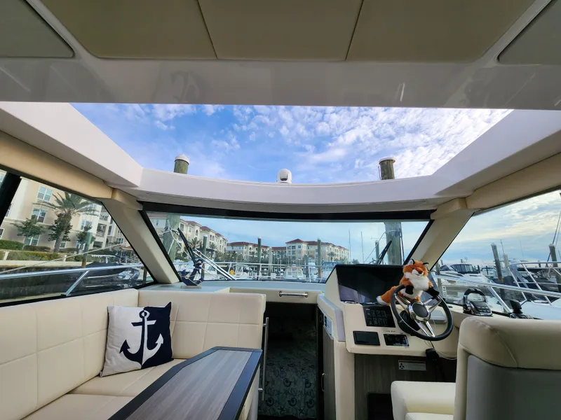 Slide: The Image of Interior view of 2022 Regal 38 Grande Coupe yacht with marina backdrop. - 20