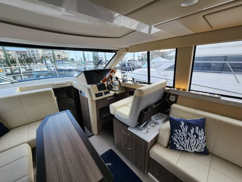 Slide: The Image of Interior of 2022 Regal 38 Grande Coupe yacht with modern seating and helm. - 21