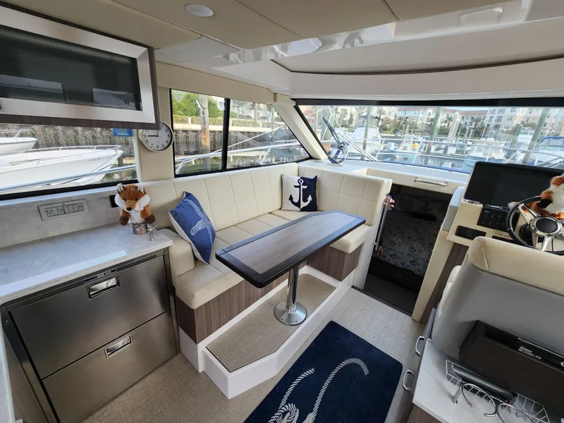 Slide: The Image of Luxurious interior of 2022 Regal 38 Grande Coupe yacht with plush seating and modern amenities. - 22