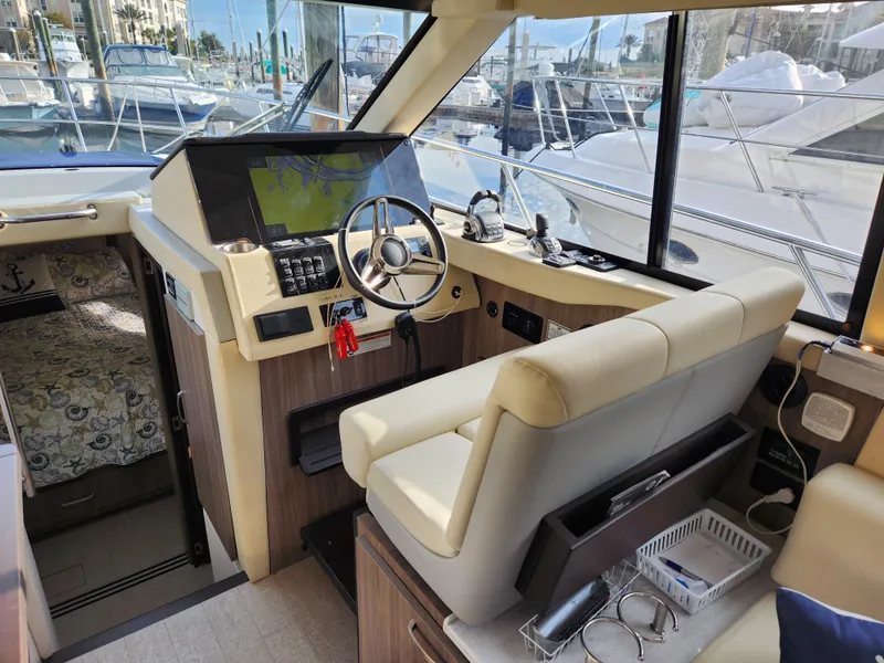 Slide: The Image of Interior of 2022 Regal 38 Grande Coupe yacht, featuring modern helm and navigation equipment. - 23