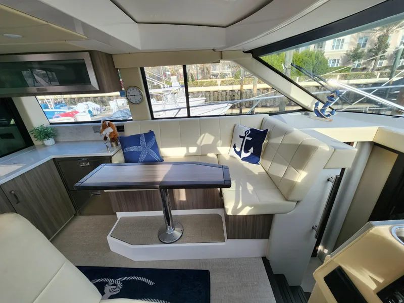 Slide: The Image of Luxurious interior of 2022 Regal 38 Grande Coupe yacht with elegant seating and nautical decor. - 24