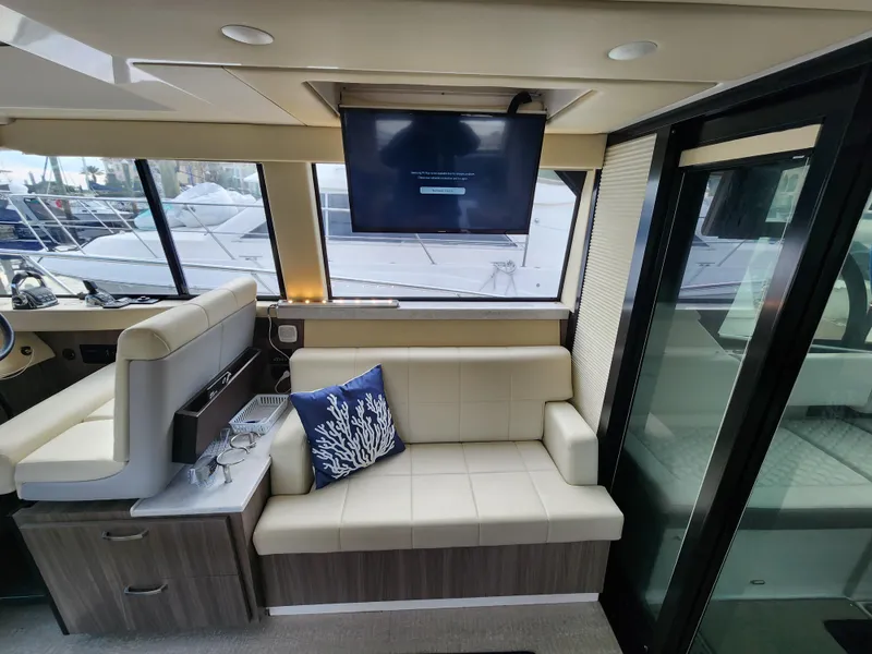 Slide: The Image of Interior of 2022 Regal 38 Grande Coupe with modern seating and TV. - 25