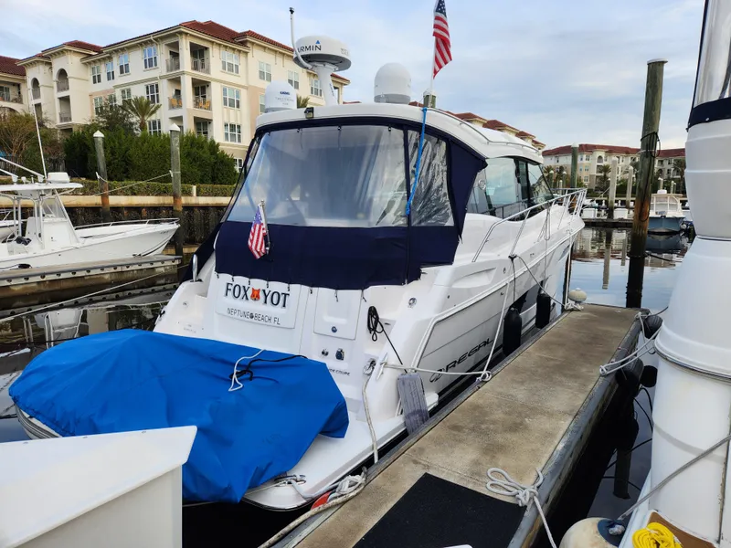 Slide: The Image of 2022 Regal 38 Grande Coupe docked at marina with American flag. - 3