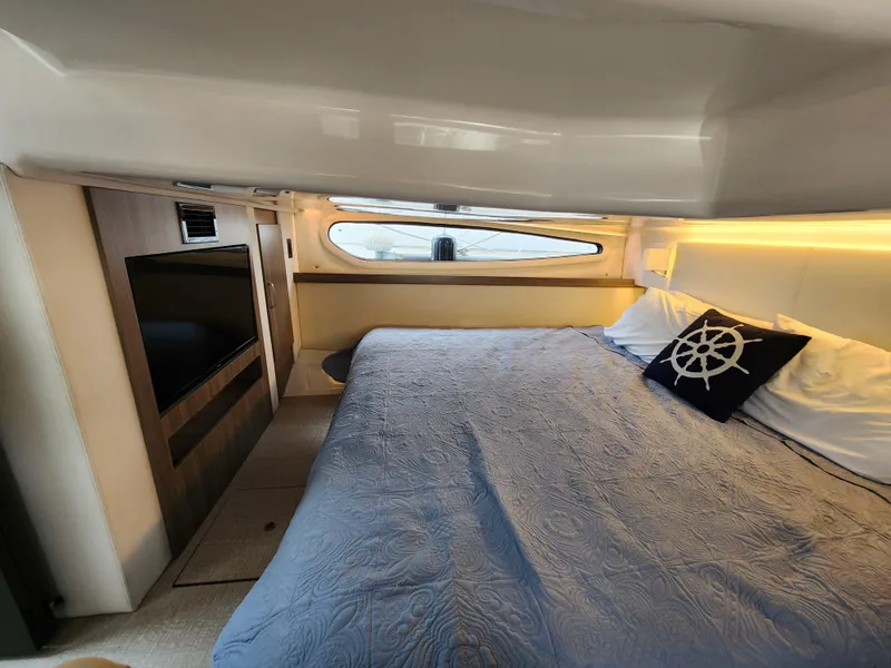 Slide: The Image of Luxurious cabin interior of 2022 Regal 38 Grande Coupe yacht with cozy bedding. - 31