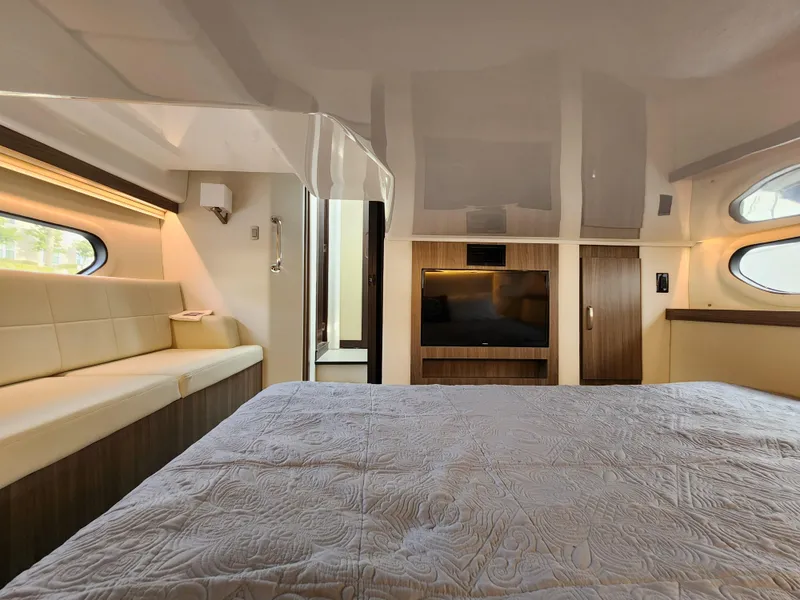 Slide: The Image of Luxurious interior of 2022 Regal 38 Grande Coupe yacht bedroom with modern amenities. - 32