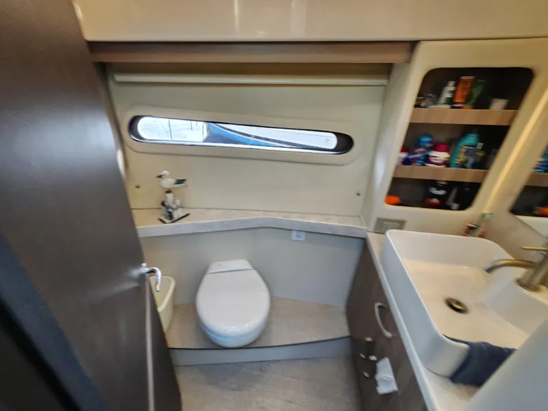 Slide: The Image of Bathroom interior of 2022 Regal 38 Grande Coupe yacht, featuring modern fixtures and storage. - 33