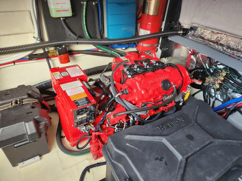 Slide: The Image of Engine room of 2022 Regal 38 Grande Coupe with red engine and wiring. - 37