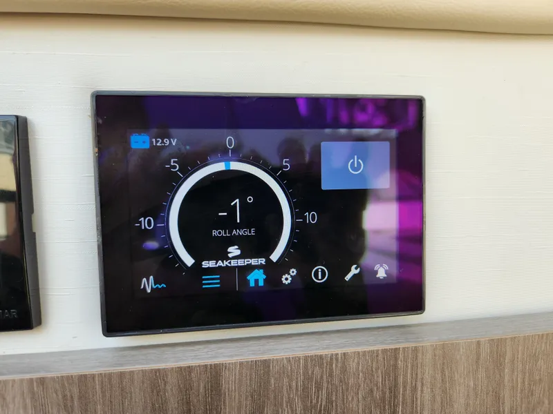 Slide: The Image of Seakeeper control panel on 2022 Regal 38 Grande Coupe, displaying roll angle and battery voltage. - 44