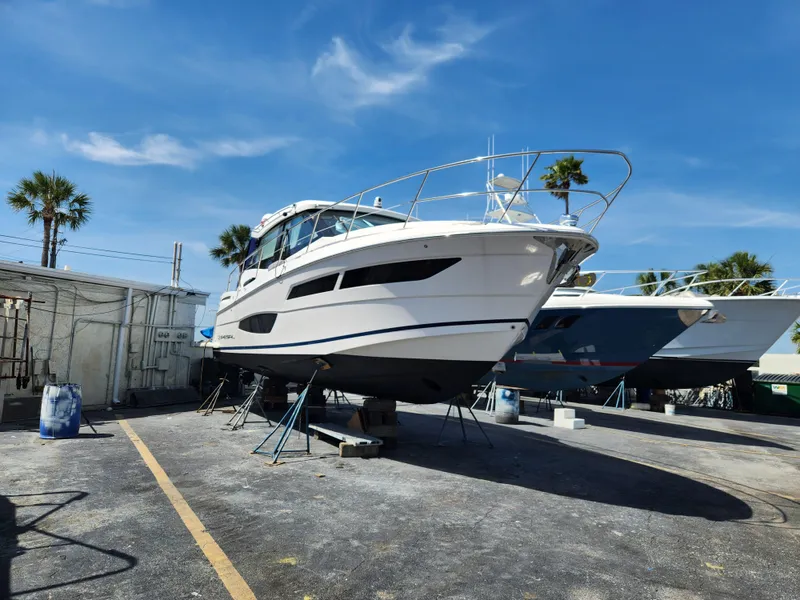 Slide: The Image of 2022 Regal 38 Grande Coupe yacht on dry dock under clear blue sky. - 48