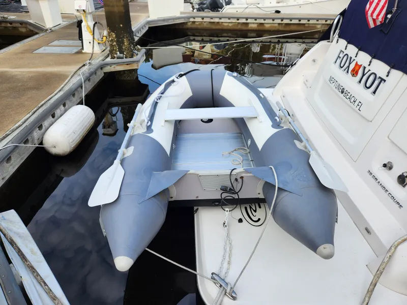 Slide: The Image of Inflatable dinghy docked beside 2022 Regal 38 Grande Coupe yacht. - 5
