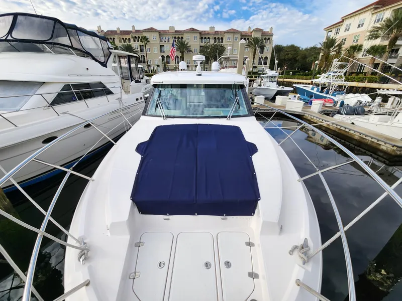 Slide: The Image of 2022 Regal 38 Grande Coupe yacht docked at marina, front view. - 6