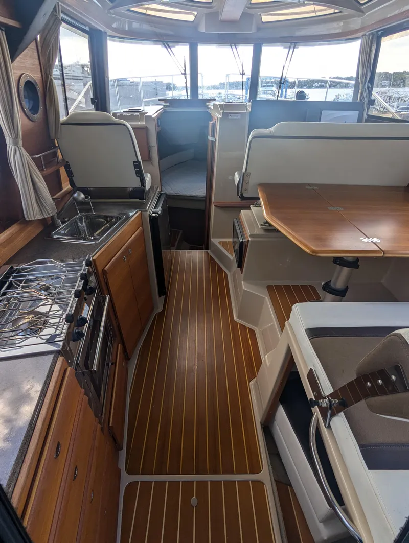 Slide: The Image of Interior of 2017 Ranger Tugs R-298 boat with wood flooring and modern amenities. - 5