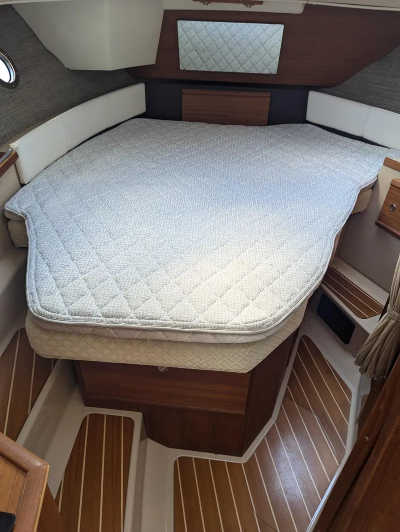 Slide: The Image of 2017 Ranger Tugs R-298 cabin interior with bed and wood flooring. - 6