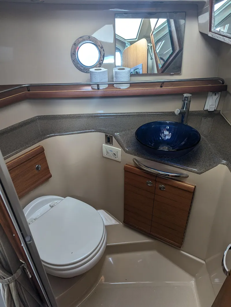 Slide: The Image of 2017 Ranger Tugs R-298 bathroom with modern sink and toilet. - 7