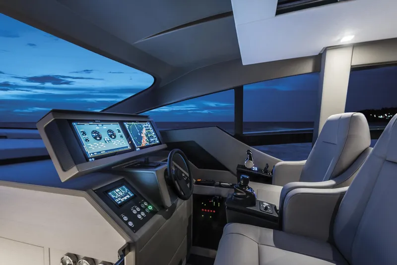 Slide: The Image of 2026 Pershing 7X yacht cockpit with advanced navigation systems and luxurious seating at dusk. - 18
