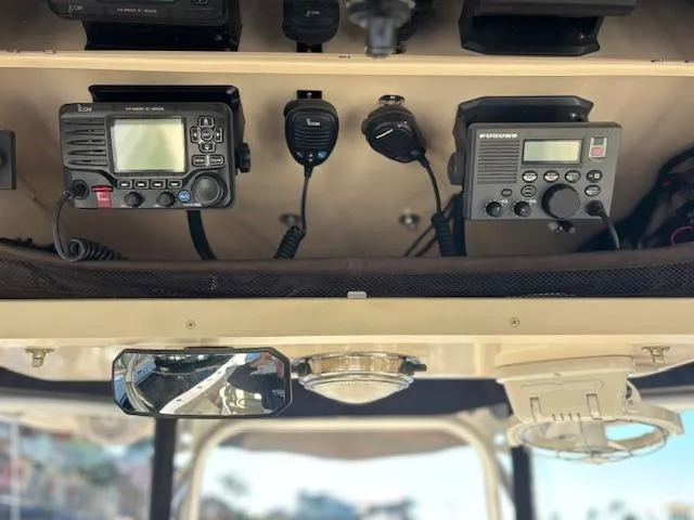 Slide: The Image of 2011 Grady-White Canyon 306 boat electronics, featuring communication devices and controls. - 17
