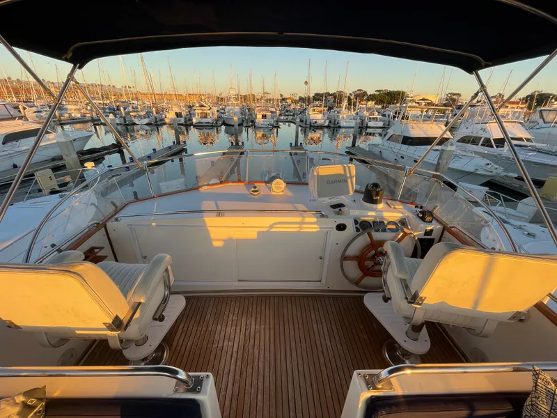 Slide: The Image of 1995 Grand Banks 49 Motoryacht cockpit with marina view at sunset. - 16