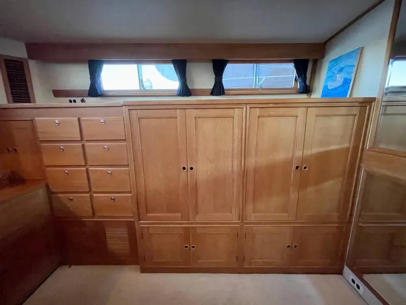 Slide: The Image of Wooden cabinetry in 1995 Grand Banks 49 Motoryacht interior, featuring ample storage and natural light. - 26
