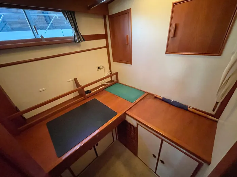 Slide: The Image of Interior of 1995 Grand Banks 49 Motoryacht with wooden cabinetry and workspace. - 30