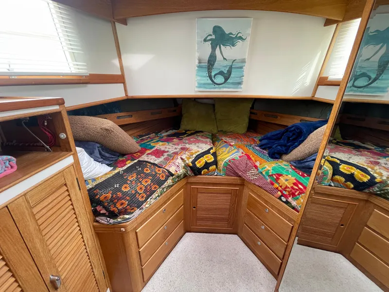 Slide: The Image of Cozy cabin interior of 1995 Grand Banks 49 Motoryacht with colorful bedding and mermaid artwork. - 33