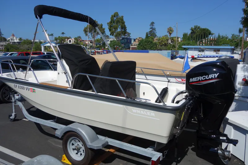 Slide: The Image of 2023 Boston Whaler 150 Montauk boat with Mercury engine on trailer. - 14