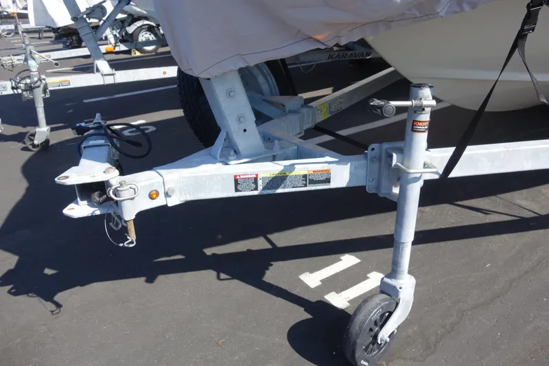 Slide: The Image of Trailer hitch of 2023 Boston Whaler 150 Montauk boat in parking lot. - 5