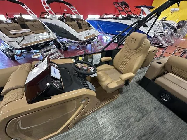 Slide: The Image of 2025 Godfrey Pontoons Monaco 235 DFL GTP in garage, showcasing luxurious seating and design. - 10