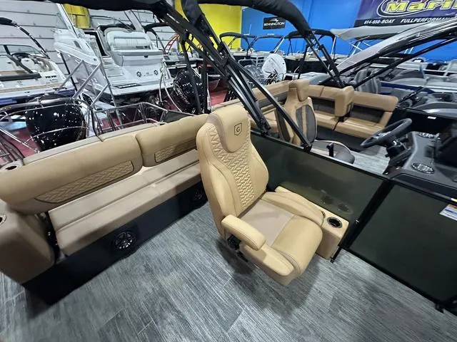 Slide: The Image of 2025 Godfrey Pontoons Monaco 235 DFL interior with tan seating and modern design. - 11