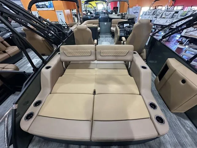 Slide: The Image of Luxurious interior of 2025 Godfrey Pontoons Monaco 235 DFL with tan seating and cup holders. - 15