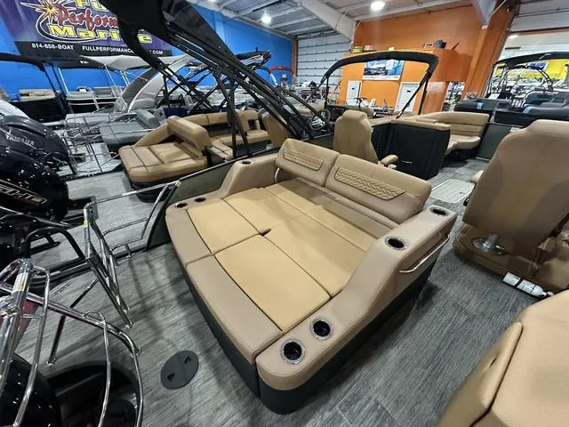 Slide: The Image of 2025 Godfrey Pontoons Monaco 235 DFL GTP with luxurious tan seating and modern helm. - 17