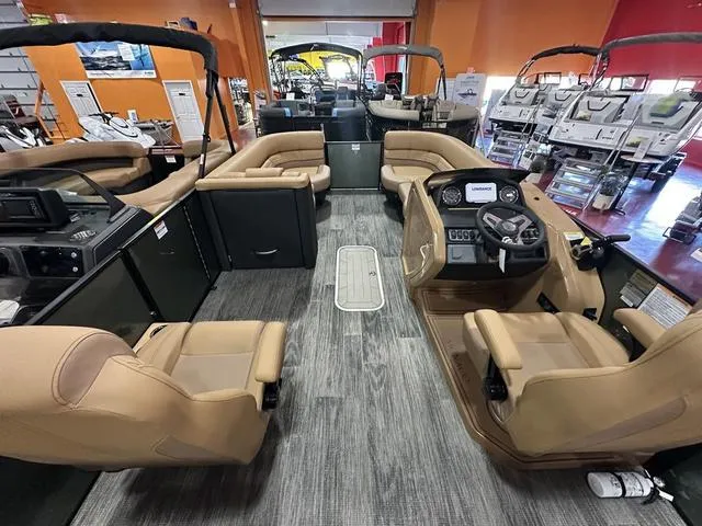 Slide: The Image of 2025 Godfrey Pontoons Monaco 235 DFL GTP interior with luxurious seating and modern dashboard. - 19