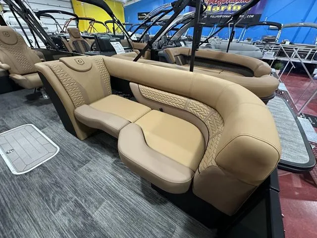 Slide: The Image of 2025 Godfrey Pontoons Monaco 235 DFL GTP in showroom, sleek design, black canopy. - 4