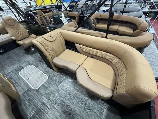 Slide: The Image of 2025 Godfrey Pontoons Monaco 235 DFL with luxurious seating and modern design in showroom. - 6