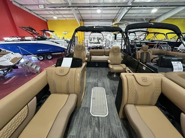 Slide: The Image of 2025 Godfrey Pontoons Monaco 235 DFL GTP with luxurious seating in showroom. - 7