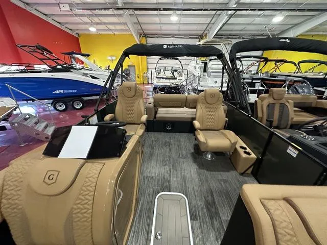 Slide: The Image of 2025 Godfrey Pontoons Monaco 235 DFL interior with tan seating and cup holders. - 8