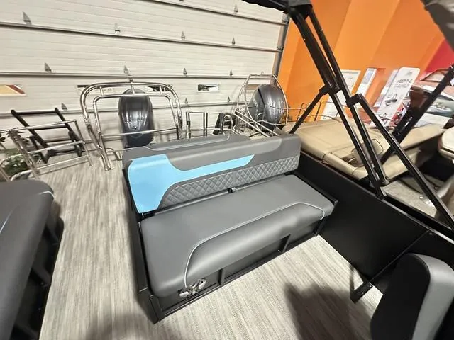 Slide: The Image of 2025 Godfrey Sweetwater 2286 SFL pontoon interior with seating and storage in a garage. - 15