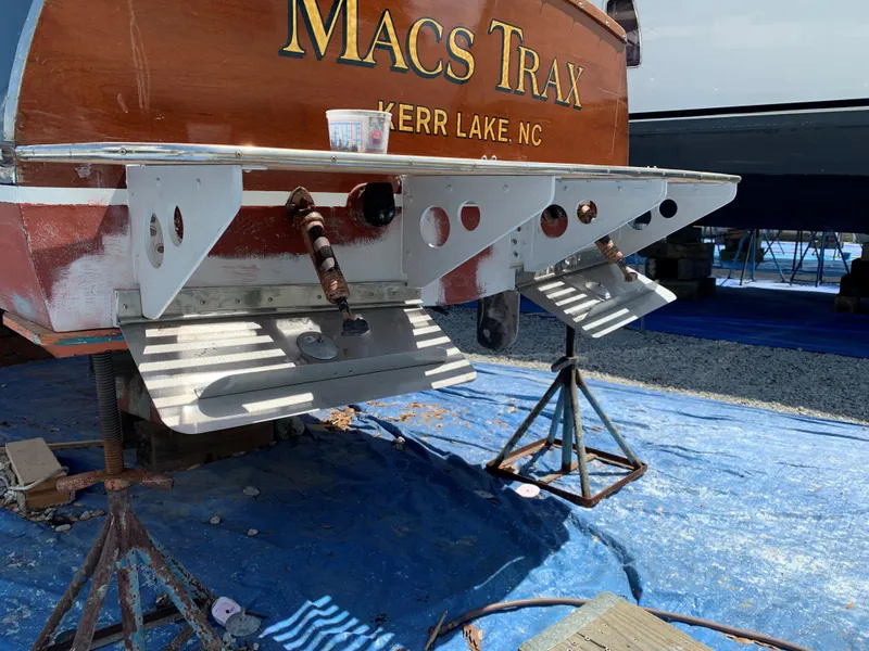 Slide: The Image of 1960 Prowler Semi-enclosed boat named "Macs Trax" at Kerr Lake, NC, on stands for maintenance. - 18