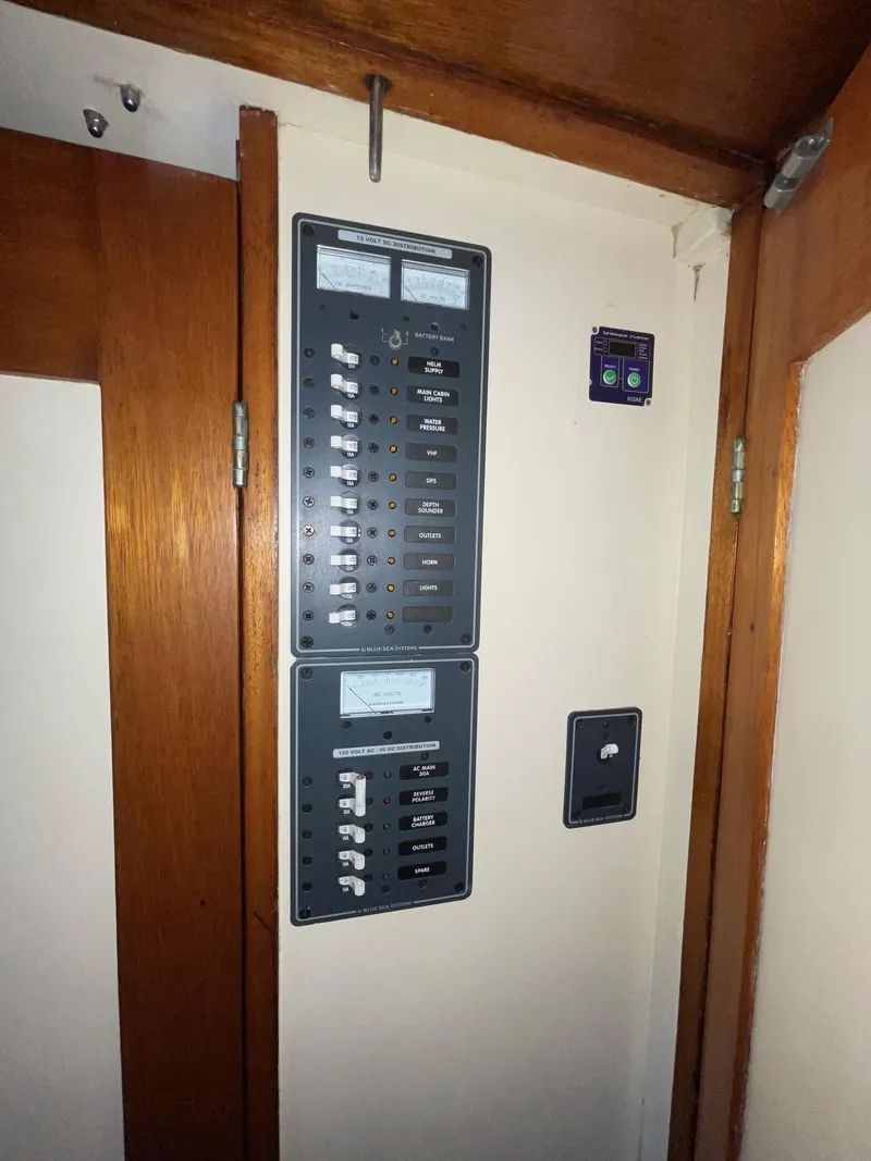 Slide: The Image of Electrical panel inside 1960 Prowler Semi-enclosed, featuring switches and meters on a wooden wall. - 20