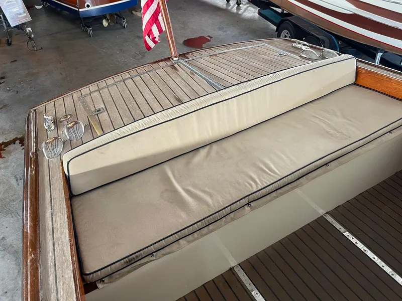 Slide: The Image of 1960 Prowler Semi-enclosed boat interior with wooden deck and cushioned seating. - 21