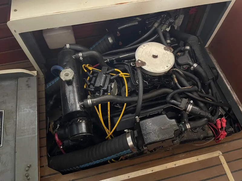 Slide: The Image of 1960 Prowler Semi-enclosed engine with visible wiring and components in a wooden compartment. - 22