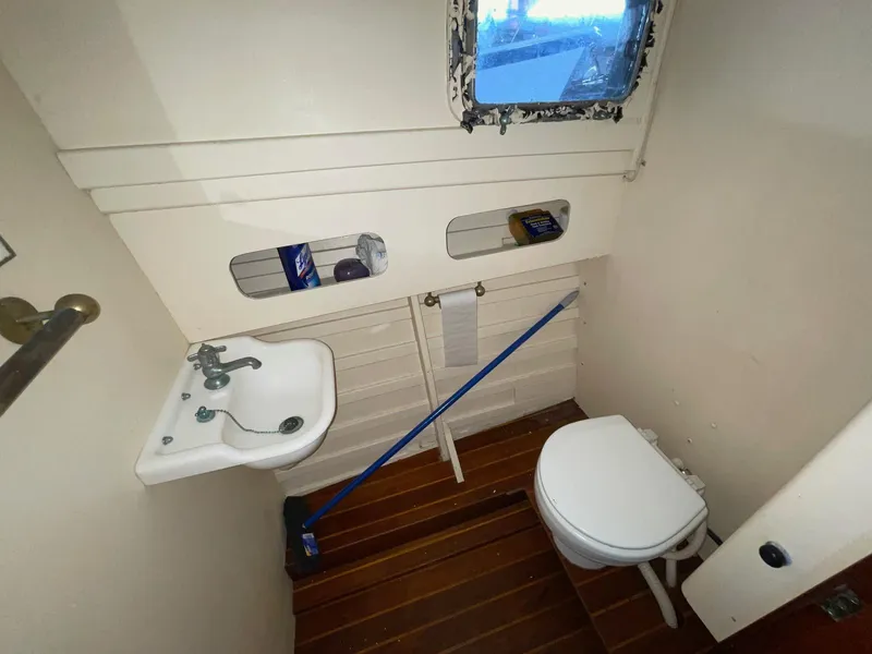 Slide: The Image of 1960 Prowler Semi-enclosed bathroom with sink, toilet, and wooden floor. - 25