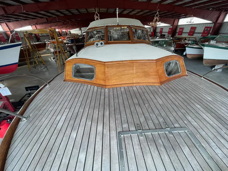 Slide: The Image of 1960 Prowler Semi-enclosed boat with wooden deck, stored indoors. - 31