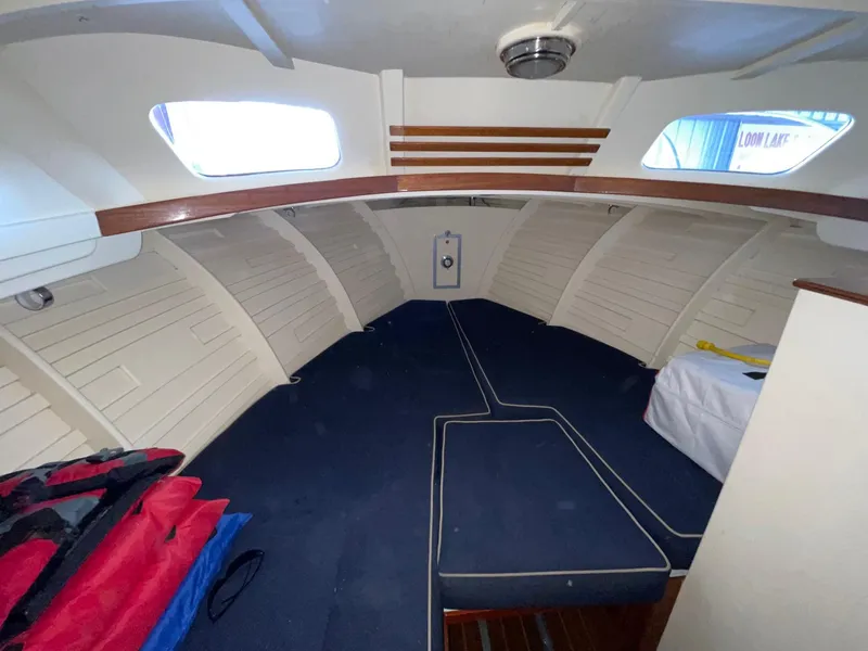 Slide: The Image of 1960 Prowler Semi-enclosed boat interior with blue cushions and white walls. - 33