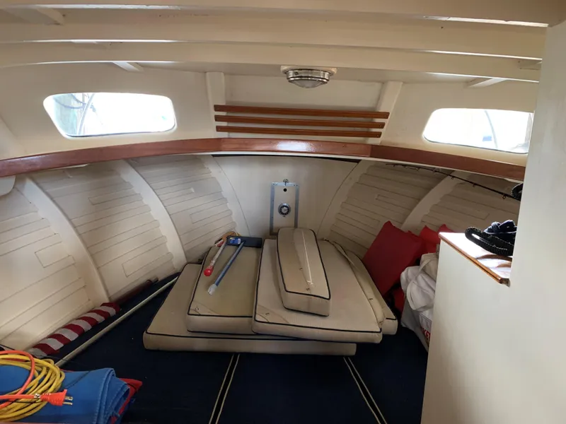 Slide: The Image of 1960 Prowler Semi-enclosed boat interior with cushions and nautical equipment. - 4