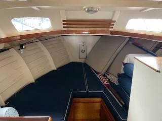 Slide: The Image of 1960 Prowler Semi-enclosed boat interior with blue seating and wooden accents. - 6