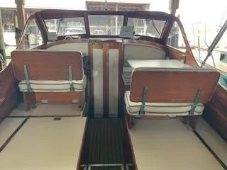 Slide: The Image of 1960 Prowler Semi-enclosed boat interior with wooden seats and steering area. - 8
