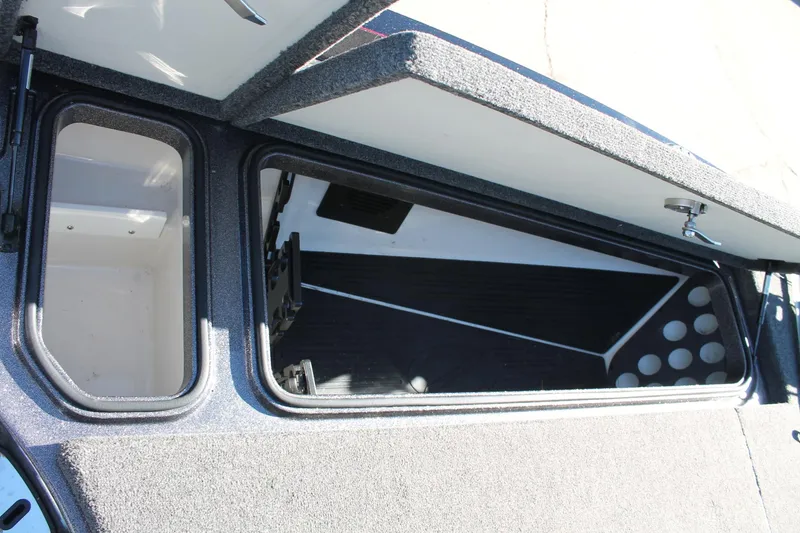 Slide: The Image of 2020 Ranger Z521L boat storage compartments with open lids. - 10